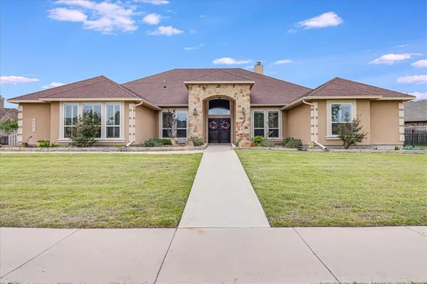 a front view of a house with garden