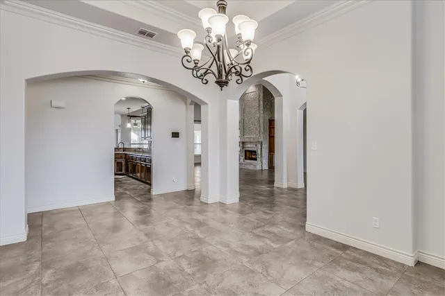 a view of a hallway with chandelier and entryway