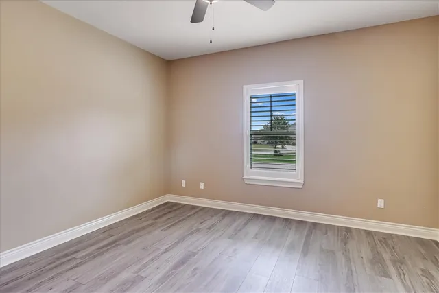 a bathroom with a granite countertop toilet sink and mirror