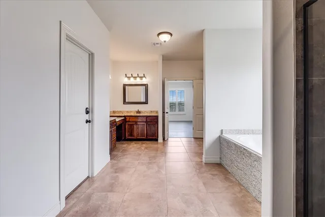 a bathroom with a glass shower door