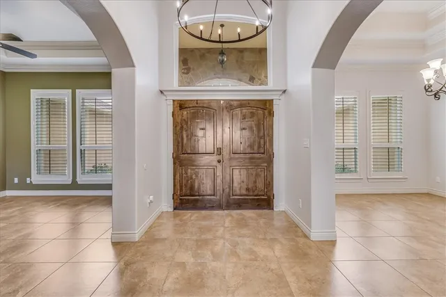 a view of a hallway with wooden floor and a kitchen