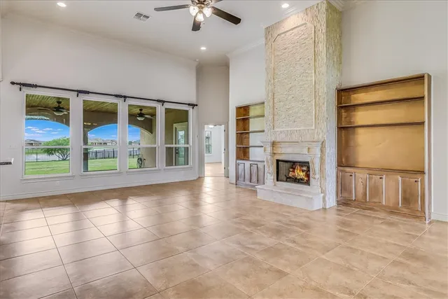 a view of an empty room with a fireplace and a window