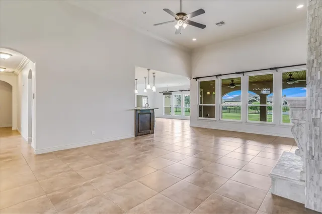 a view of a livingroom with a ceiling fan and window