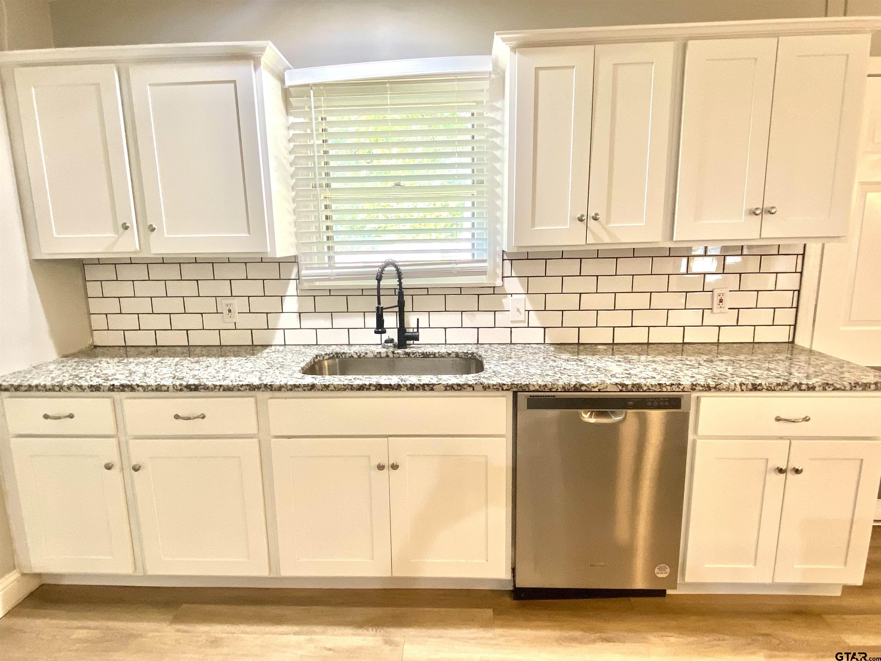 1914 Parklen Street Tyler, TX 75701 - Photo 11 of 39 a kitchen with granite countertop sink cabinets and window