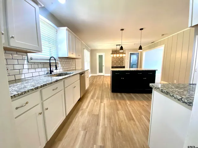 a large kitchen with granite countertop a lot of counter space