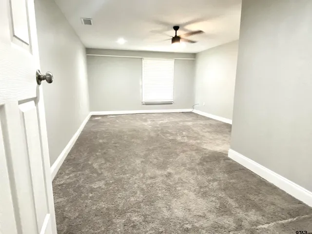 an empty room with a empty space and a window