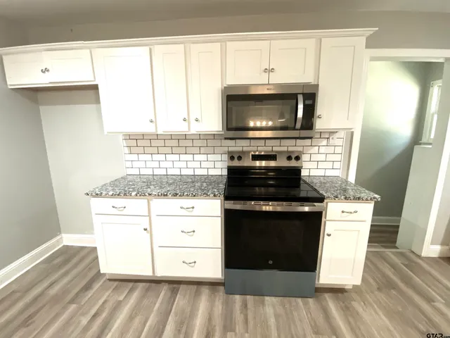 a kitchen with a stove and a microwave