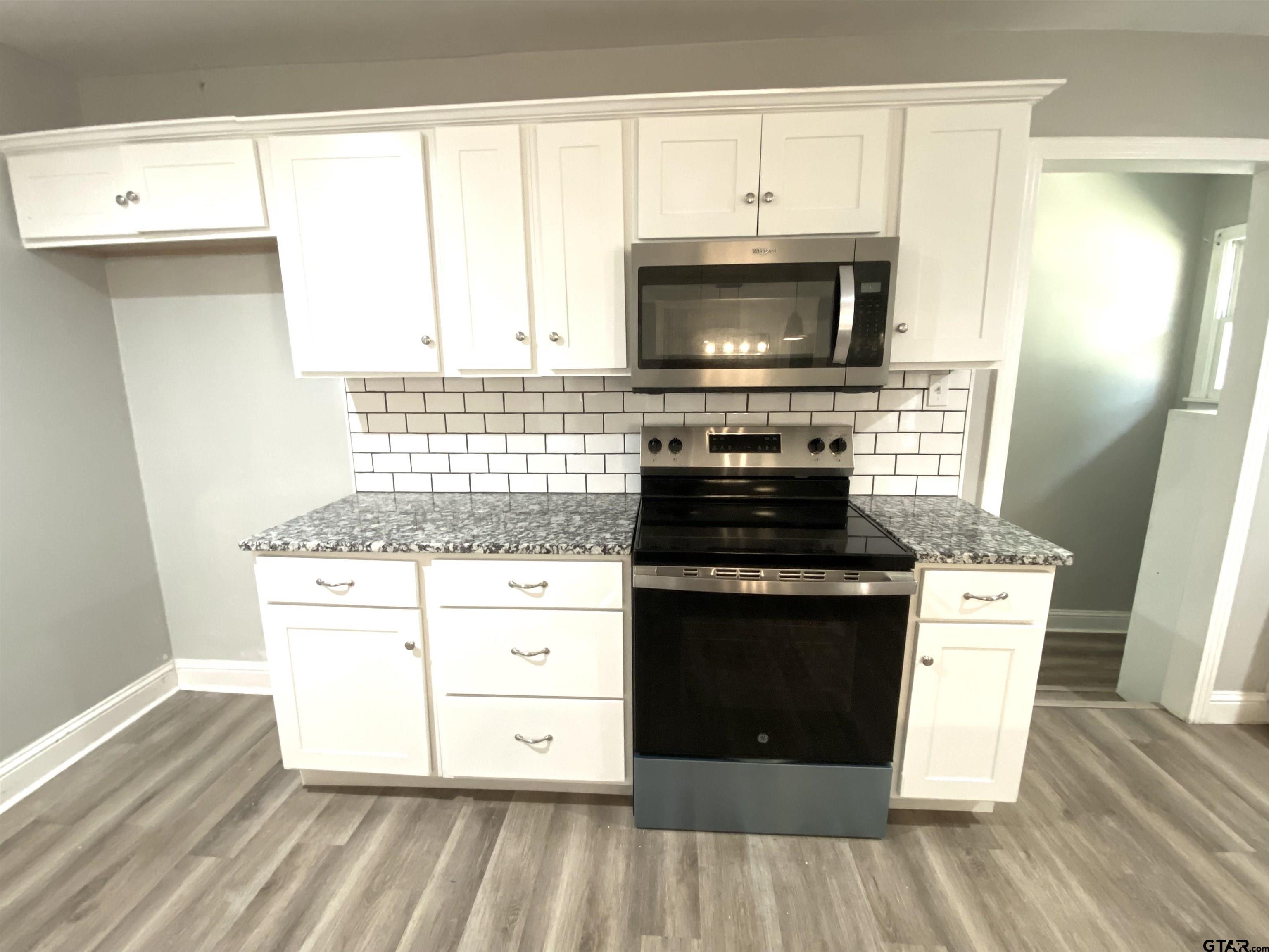 1914 Parklen Street Tyler, TX 75701 - Photo 10 of 39 a kitchen with a stove and a microwave