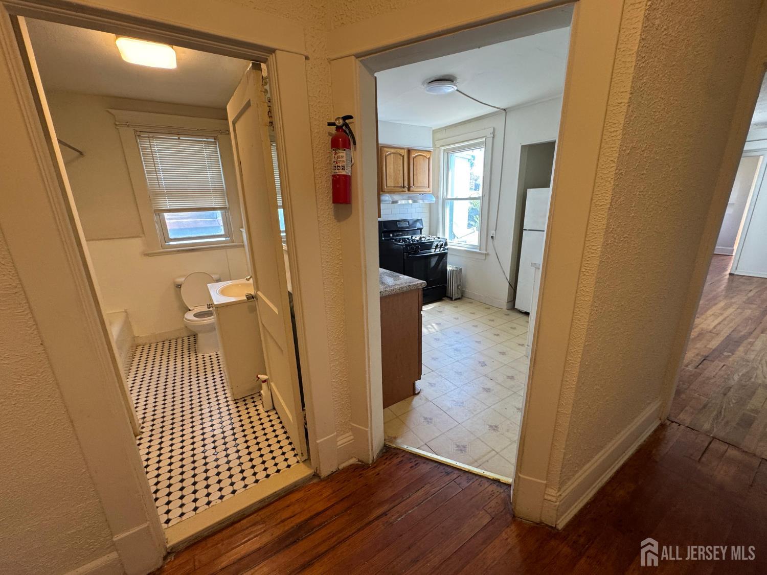 110 Rector Street, Unit 2 Perth Amboy, NJ 08861 - Photo 3 of 11 a view of a hallway view with wooden floor and staircase