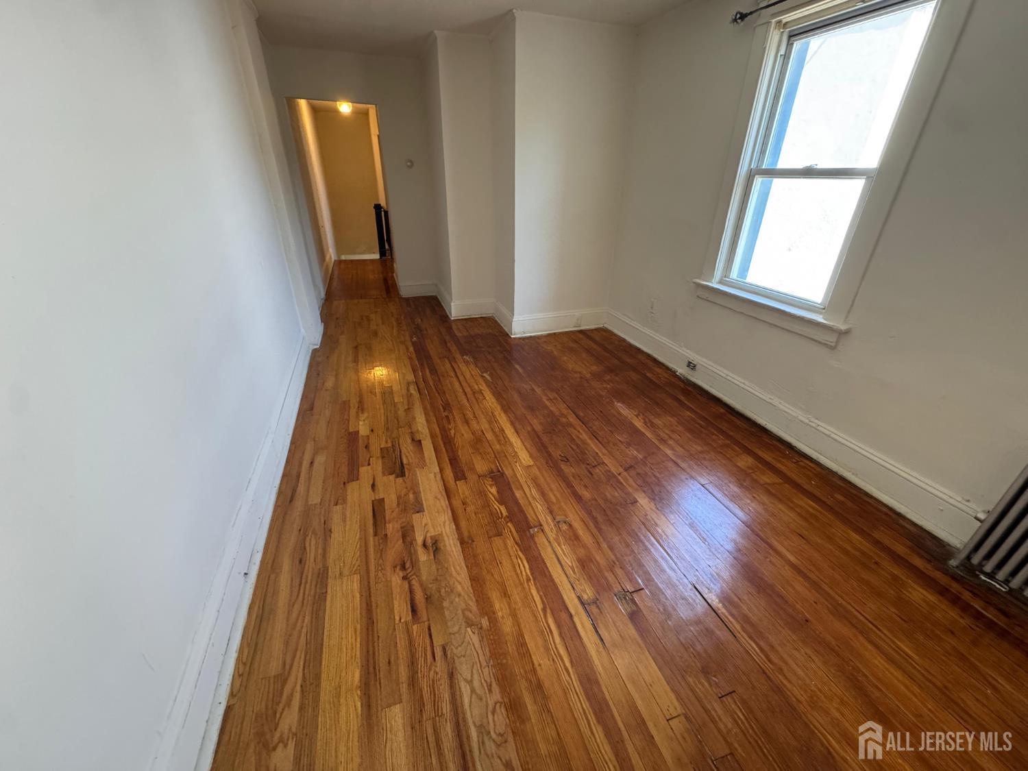 110 Rector Street, Unit 2 Perth Amboy, NJ 08861 - Photo 6 of 11 a view of wooden floor in a room