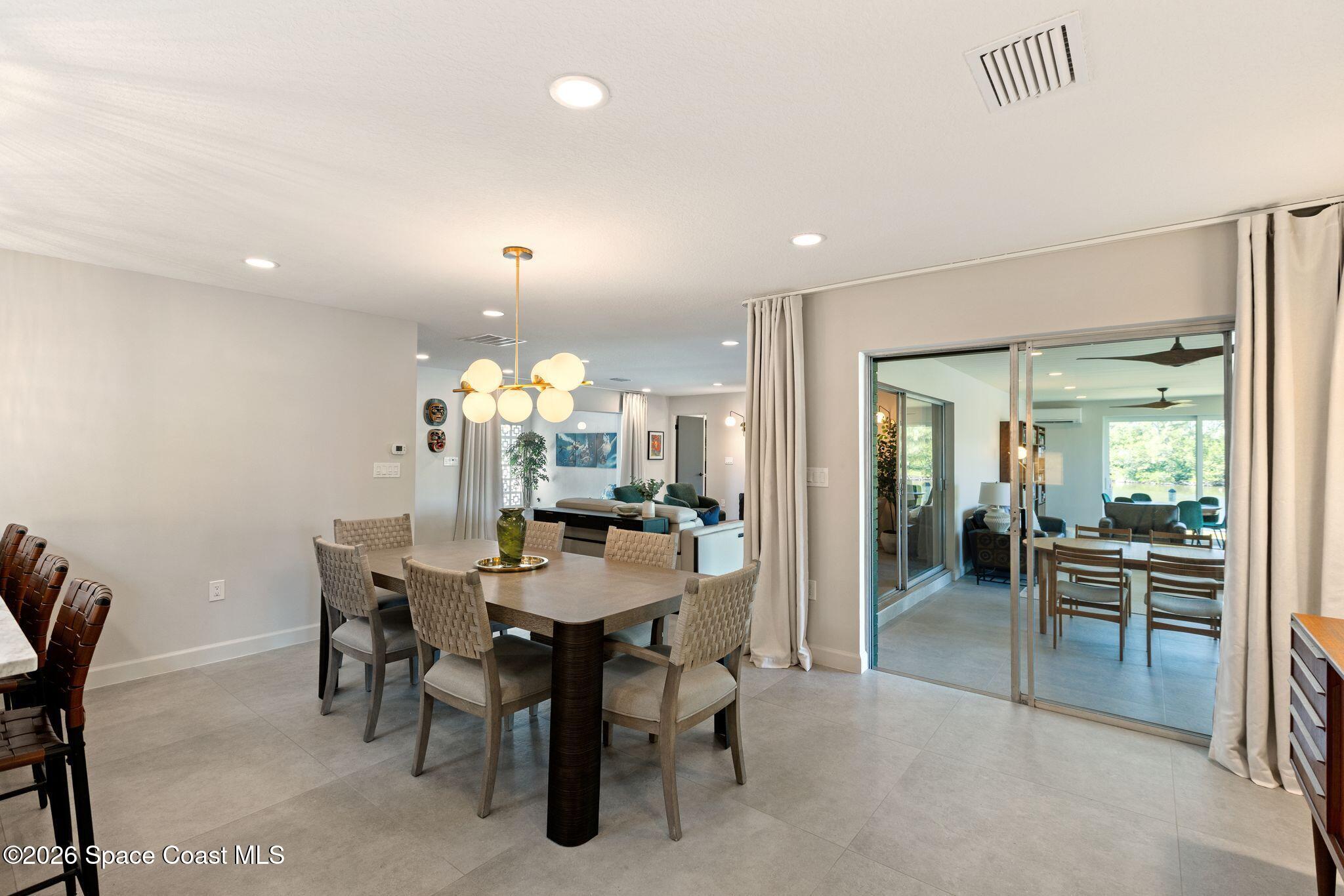1224 Samar Road Cocoa Beach, FL 32931 - Photo 11 of 56 a view of a dining room with furniture and chandelier