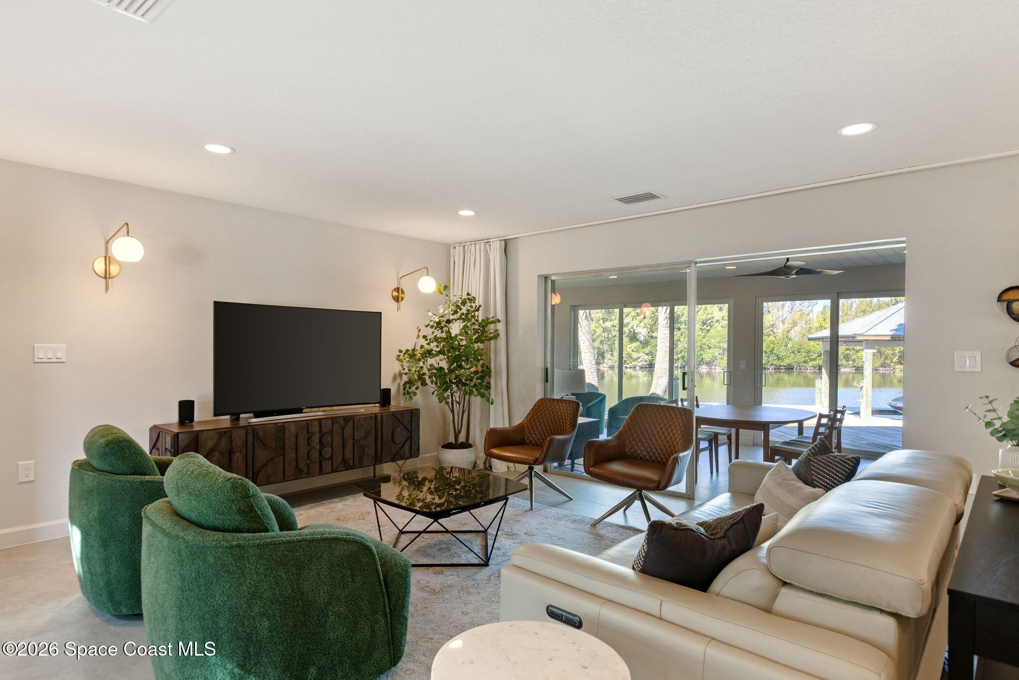 1224 Samar Road Cocoa Beach, FL 32931 - Photo 12 of 56 a living room with furniture and a flat screen tv
