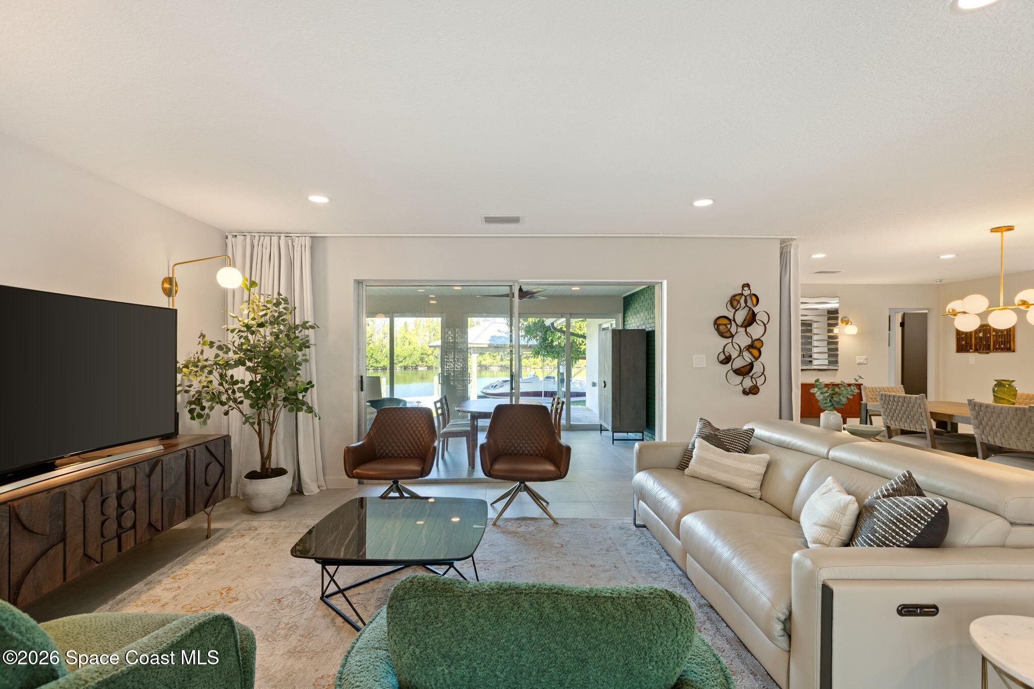 1224 Samar Road Cocoa Beach, FL 32931 - Photo 13 of 56 a living room with furniture and a flat screen tv