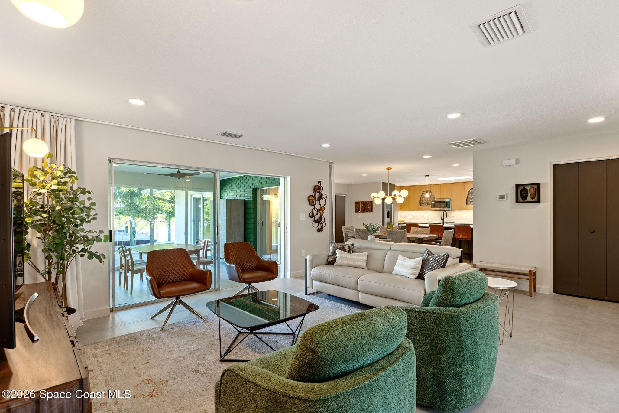 1224 Samar Road Cocoa Beach, FL 32931 - Photo 14 of 56 a living room with furniture and a large window