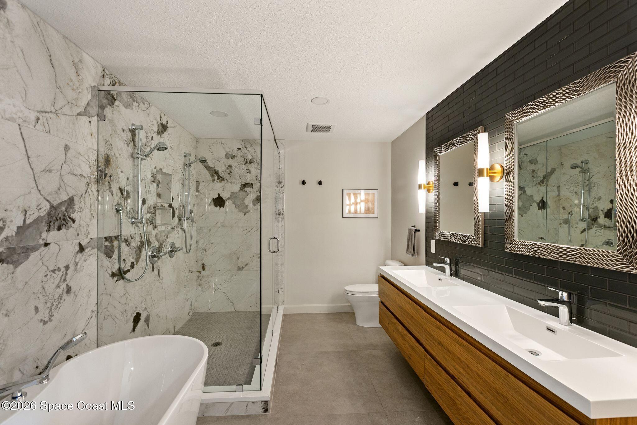 1224 Samar Road Cocoa Beach, FL 32931 - Photo 17 of 56 a bathroom with a double vanity sink toilet and shower