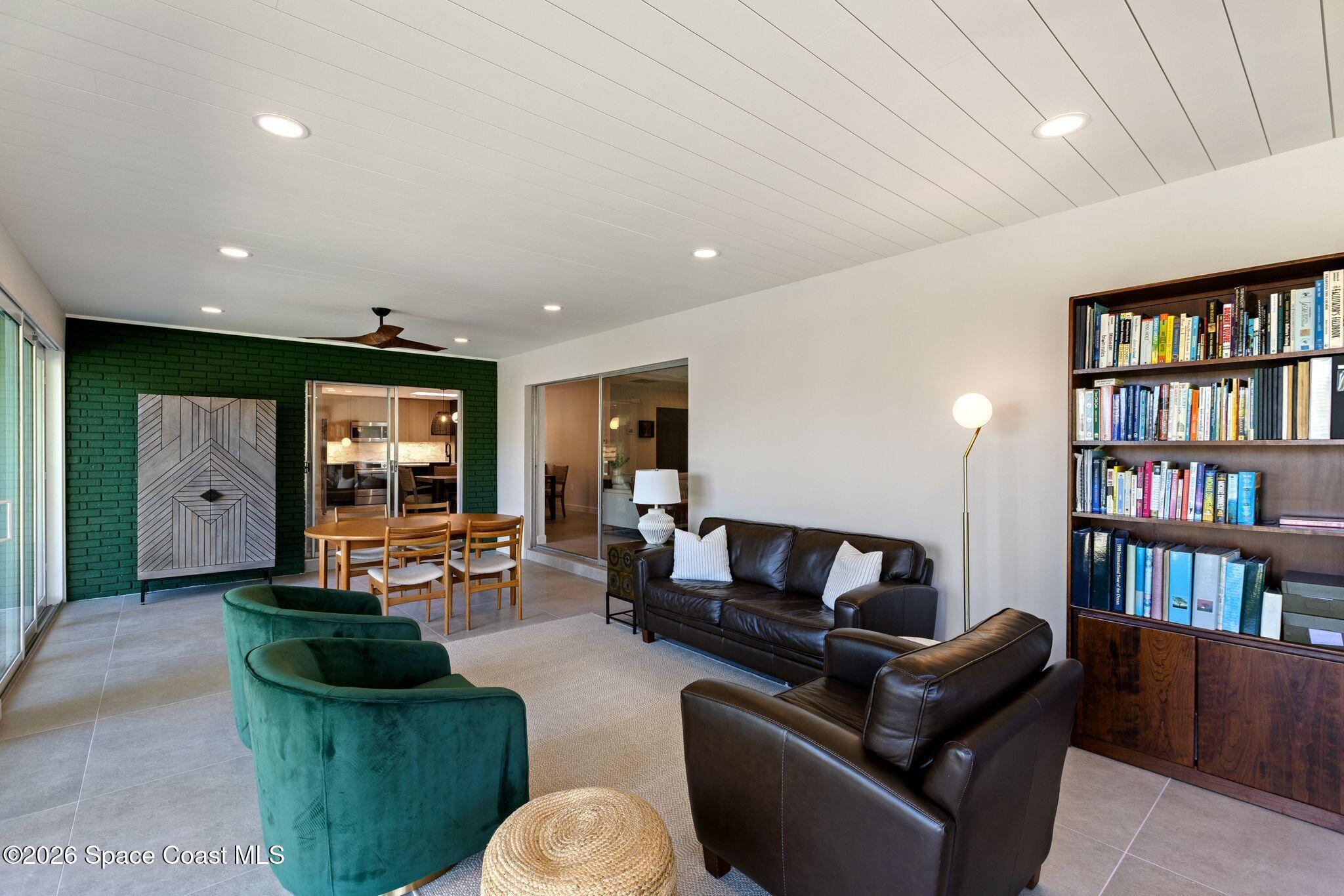 1224 Samar Road Cocoa Beach, FL 32931 - Photo 24 of 56 a living room with furniture and a book shelf