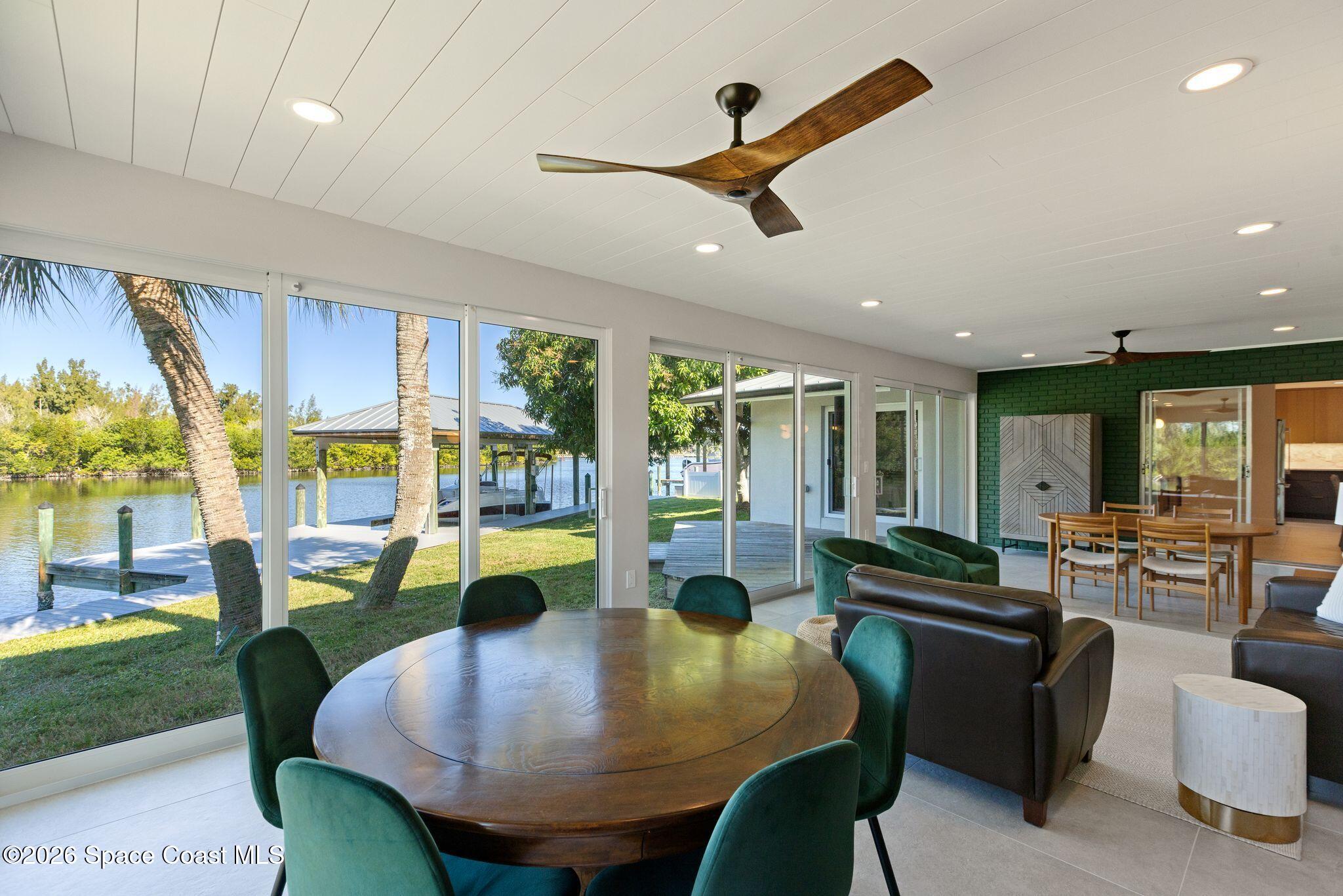 1224 Samar Road Cocoa Beach, FL 32931 - Photo 4 of 56 a living room with furniture and a large window