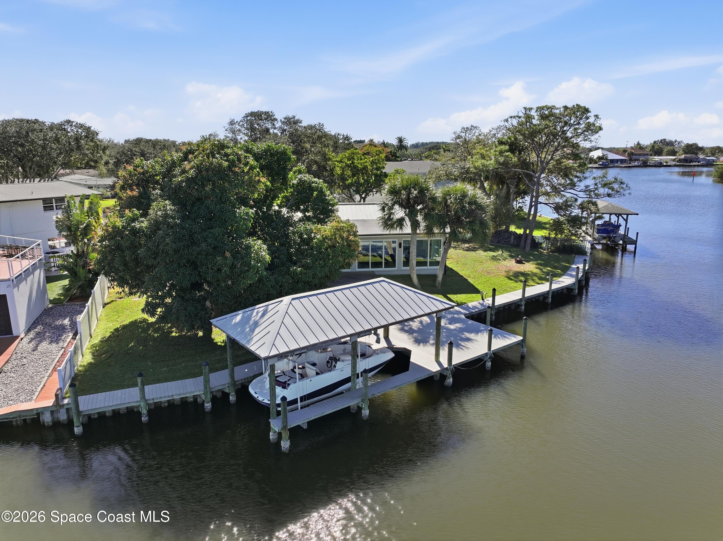 1224 Samar Road Cocoa Beach, FL 32931 - Photo 44 of 56 a view of a swimming pool with outdoor seating and plants