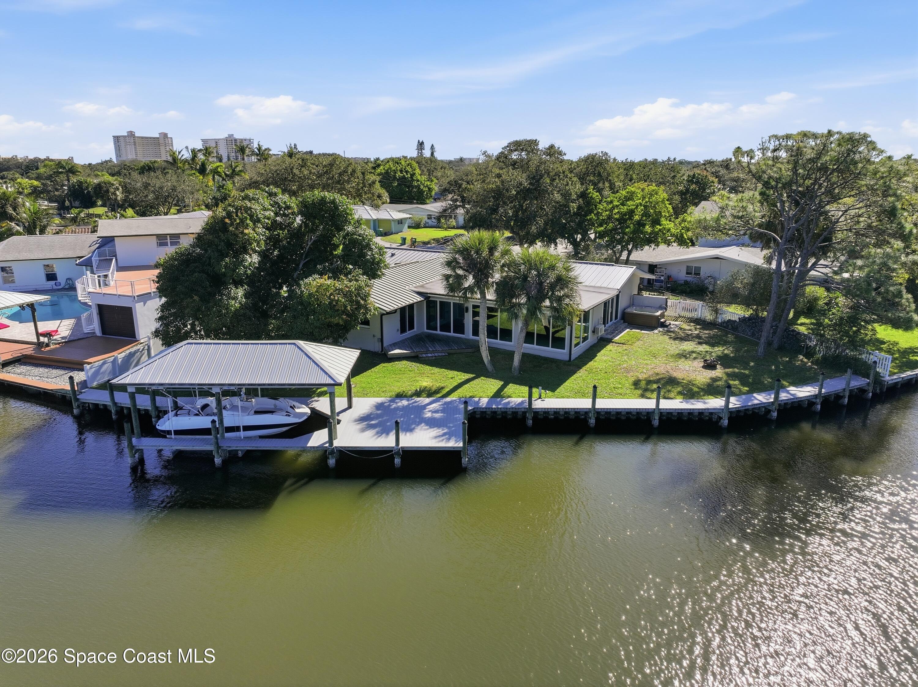 1224 Samar Road Cocoa Beach, FL 32931 - Photo 47 of 56 a view of swimming pool with outdoor seating and lake view