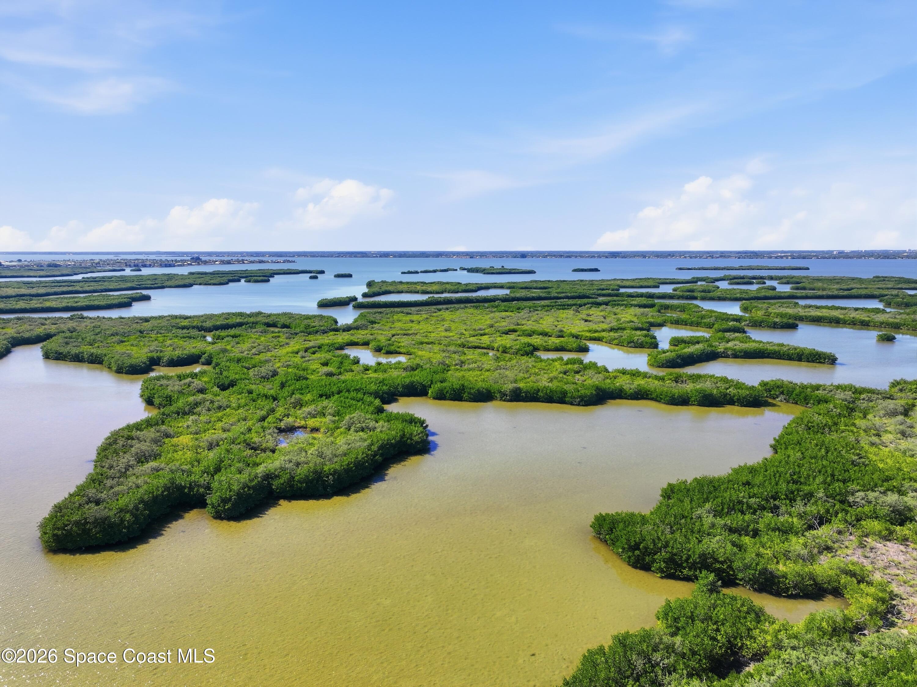 1224 Samar Road Cocoa Beach, FL 32931 - Photo 50 of 56 a view of a lake with a building in the background