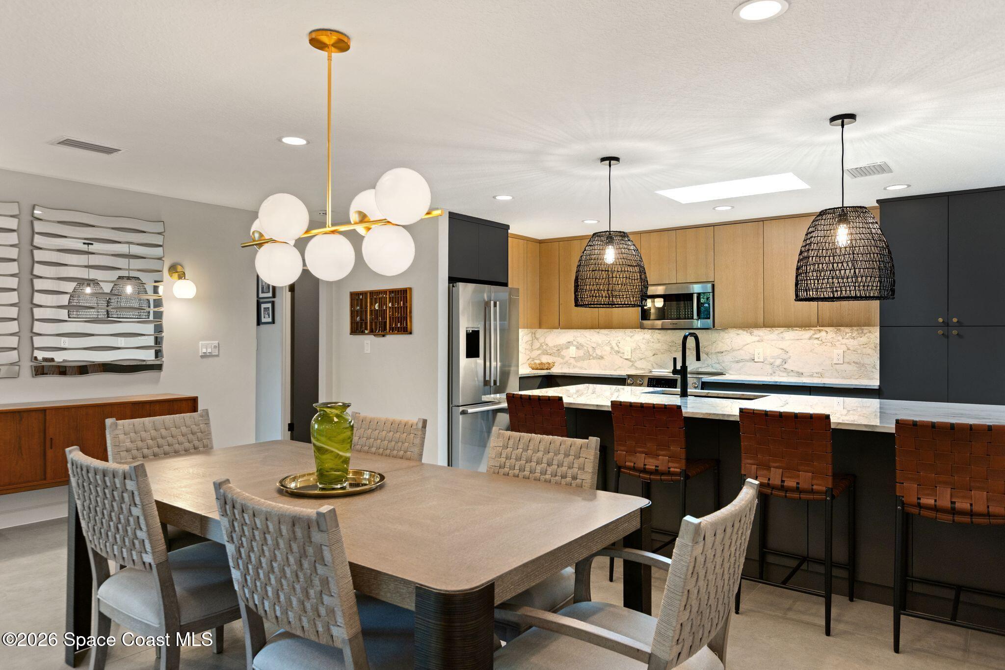 1224 Samar Road Cocoa Beach, FL 32931 - Photo 6 of 56 a kitchen with cabinets table and chairs