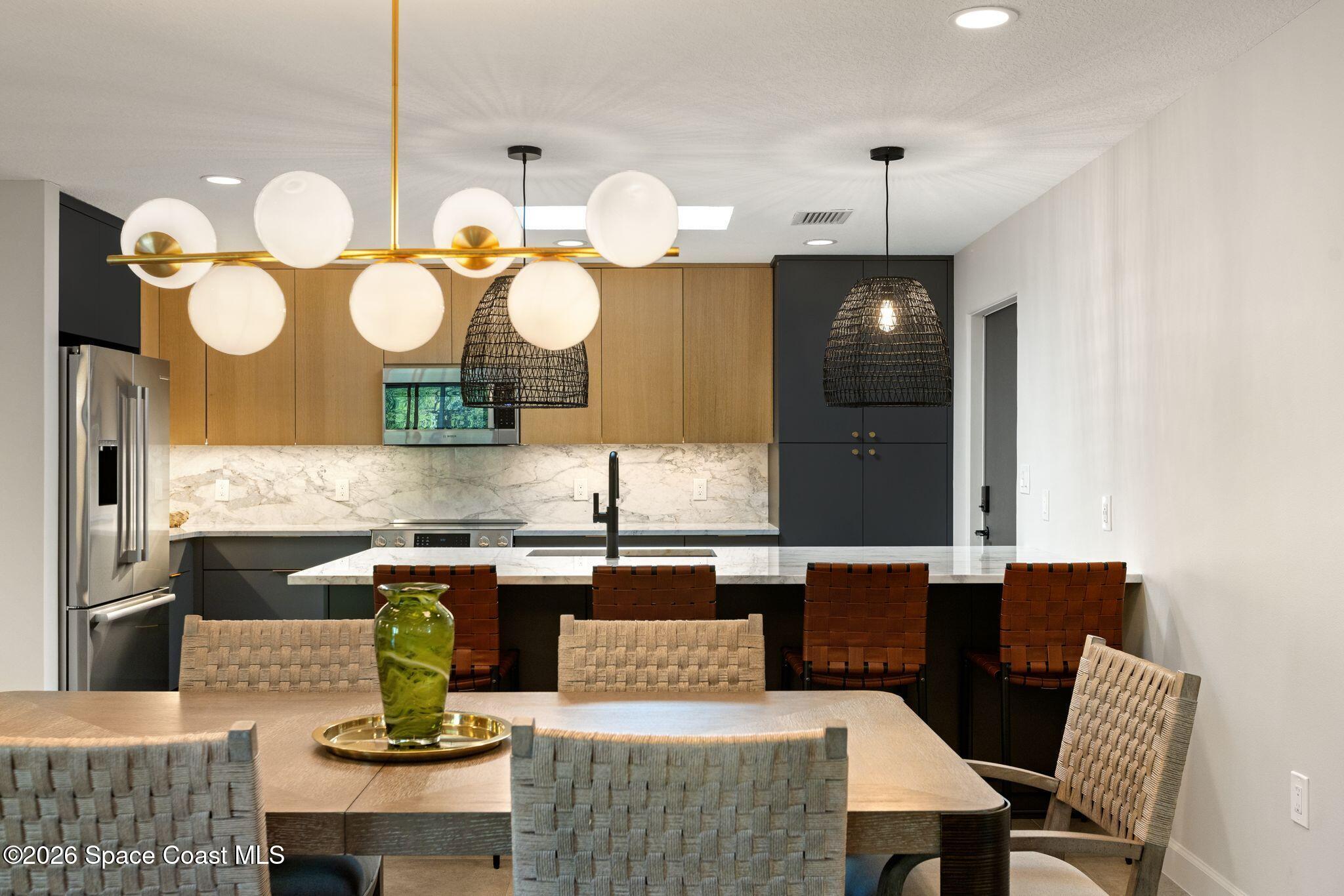 1224 Samar Road Cocoa Beach, FL 32931 - Photo 7 of 56 a kitchen with a table and chairs in it