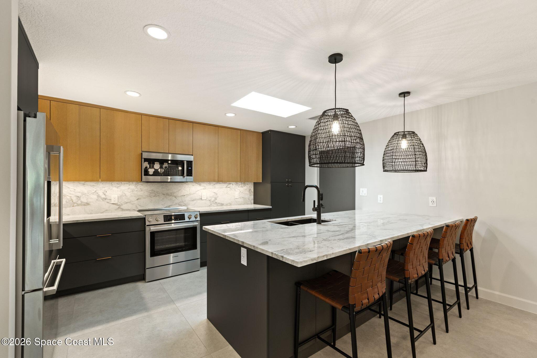 1224 Samar Road Cocoa Beach, FL 32931 - Photo 8 of 56 a kitchen with stainless steel appliances granite countertop a sink a stove and a wooden floors