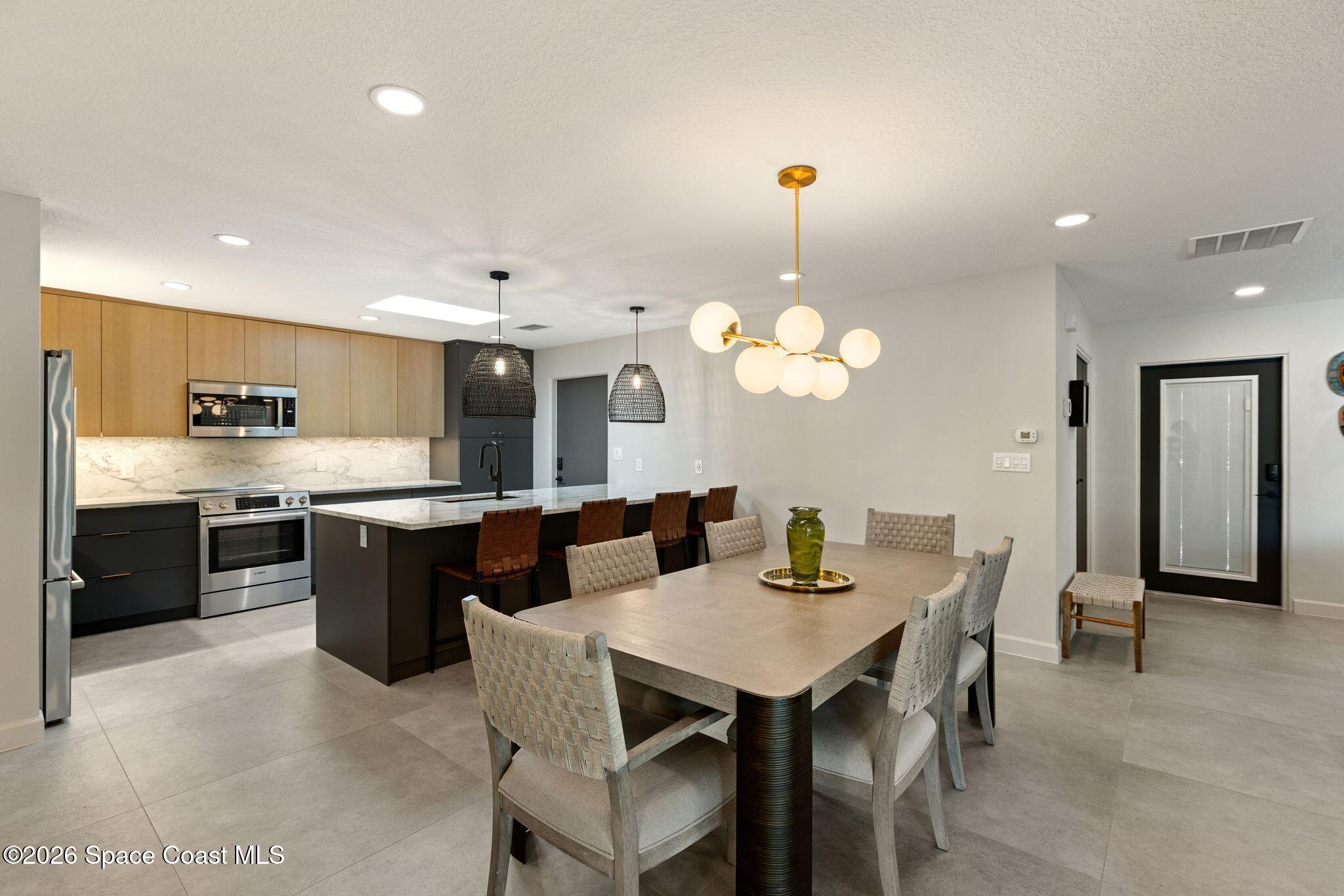 1224 Samar Road Cocoa Beach, FL 32931 - Photo 10 of 56 a large kitchen with a table and chairs