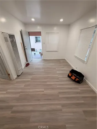 a view of a livingroom with an empty space and wooden floor