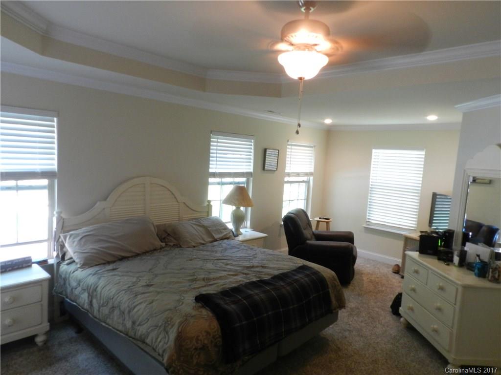 3080 Glenmoor Road York, SC 29745 - Photo 12 of 22 a bedroom with a bed and a chandelier