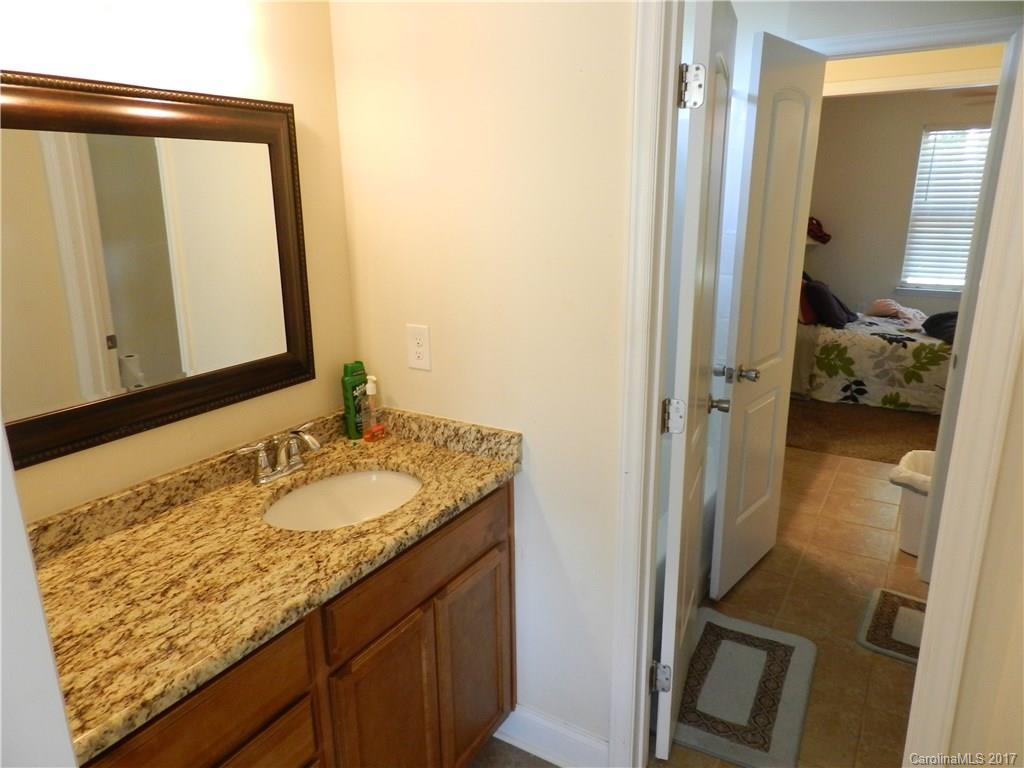 3080 Glenmoor Road York, SC 29745 - Photo 16 of 22 a en suite bathroom with a granite countertop sink and a mirror