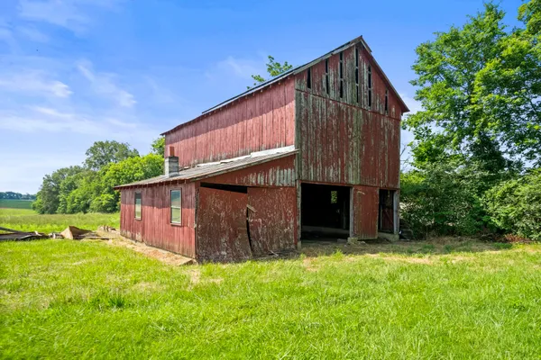 a view of backyard with potted plants and wooden fence