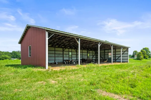 a view of a house with yard and sitting area
