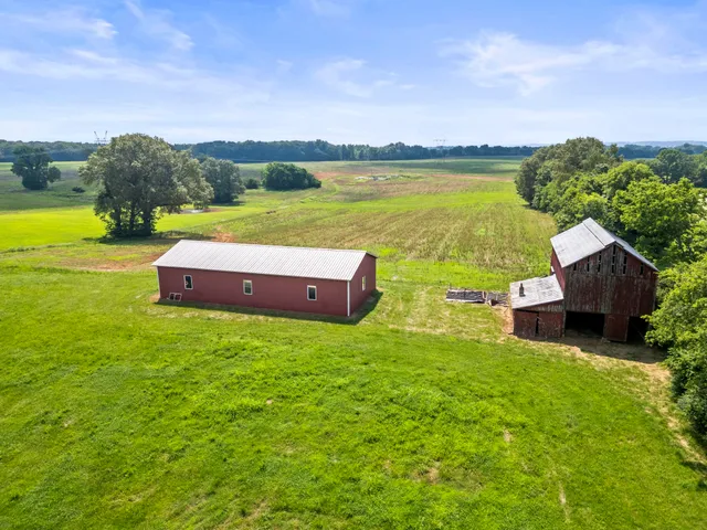 a yard with pier lake view and houses in the back
