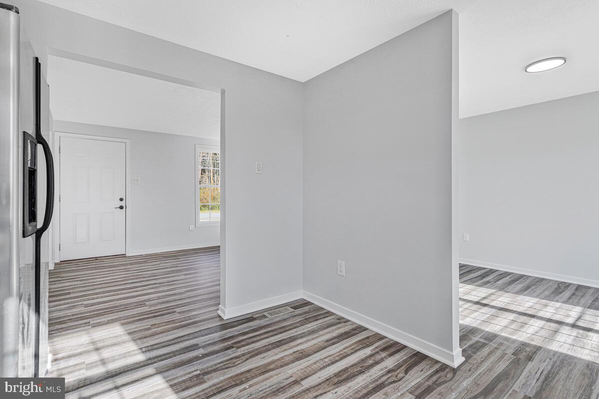 123 Cove Point Road Lusby, MD 20657 - Photo 15 of 38 a view of a room with wooden floor and bench