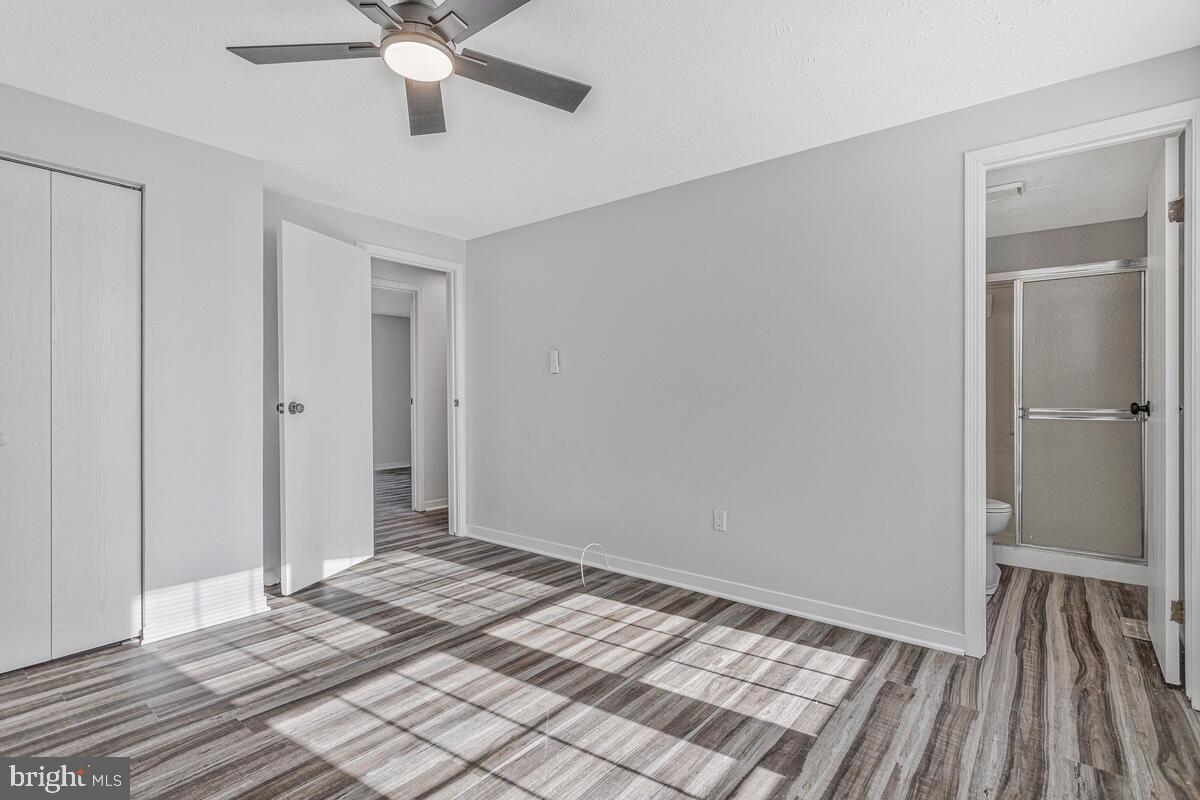 123 Cove Point Road Lusby, MD 20657 - Photo 20 of 38 a view of a room with wooden floor and ceiling fan