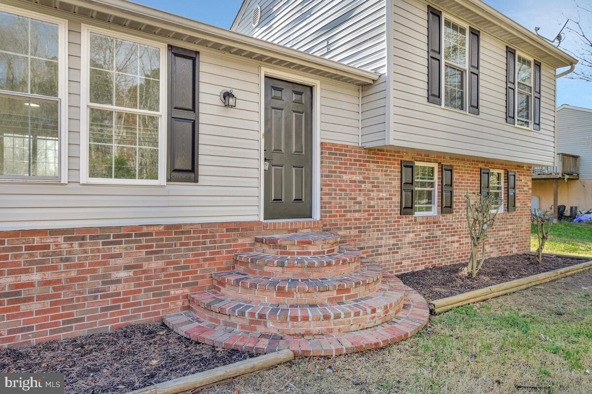 123 Cove Point Road Lusby, MD 20657 - Photo 2 of 38 a front view of a house with garden