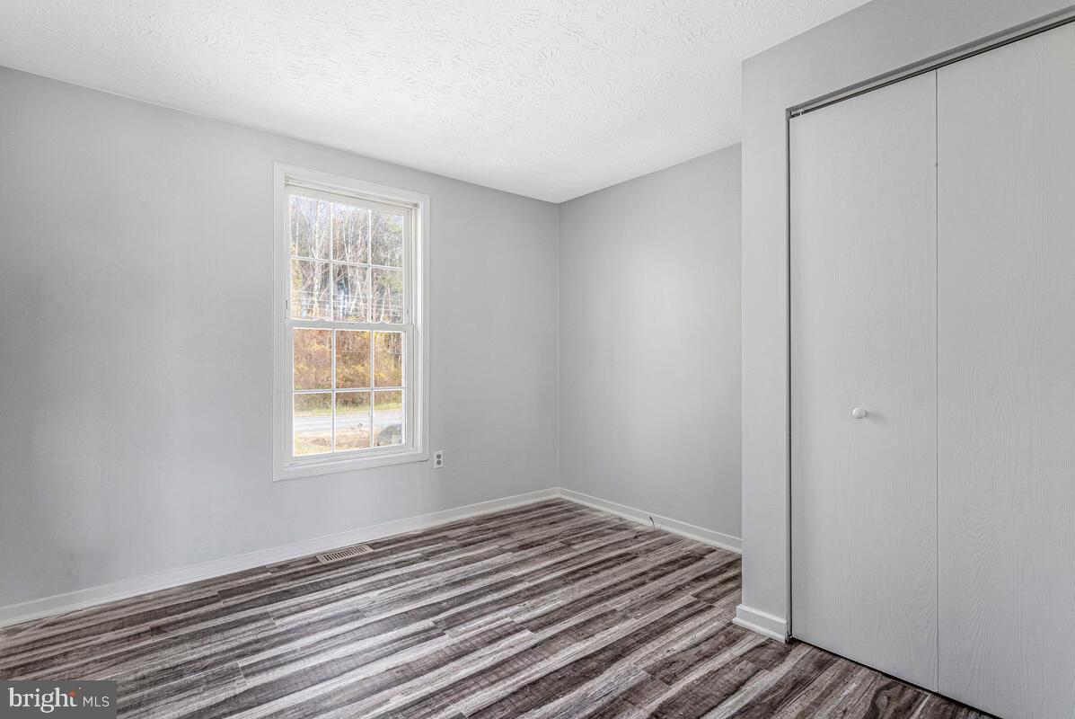 123 Cove Point Road Lusby, MD 20657 - Photo 23 of 38 a view of a room with wooden floor and cabinet