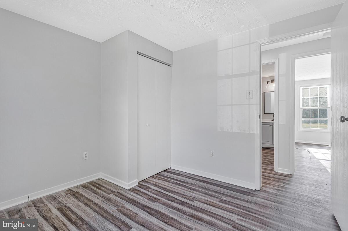 123 Cove Point Road Lusby, MD 20657 - Photo 25 of 38 wooden floor in an empty room