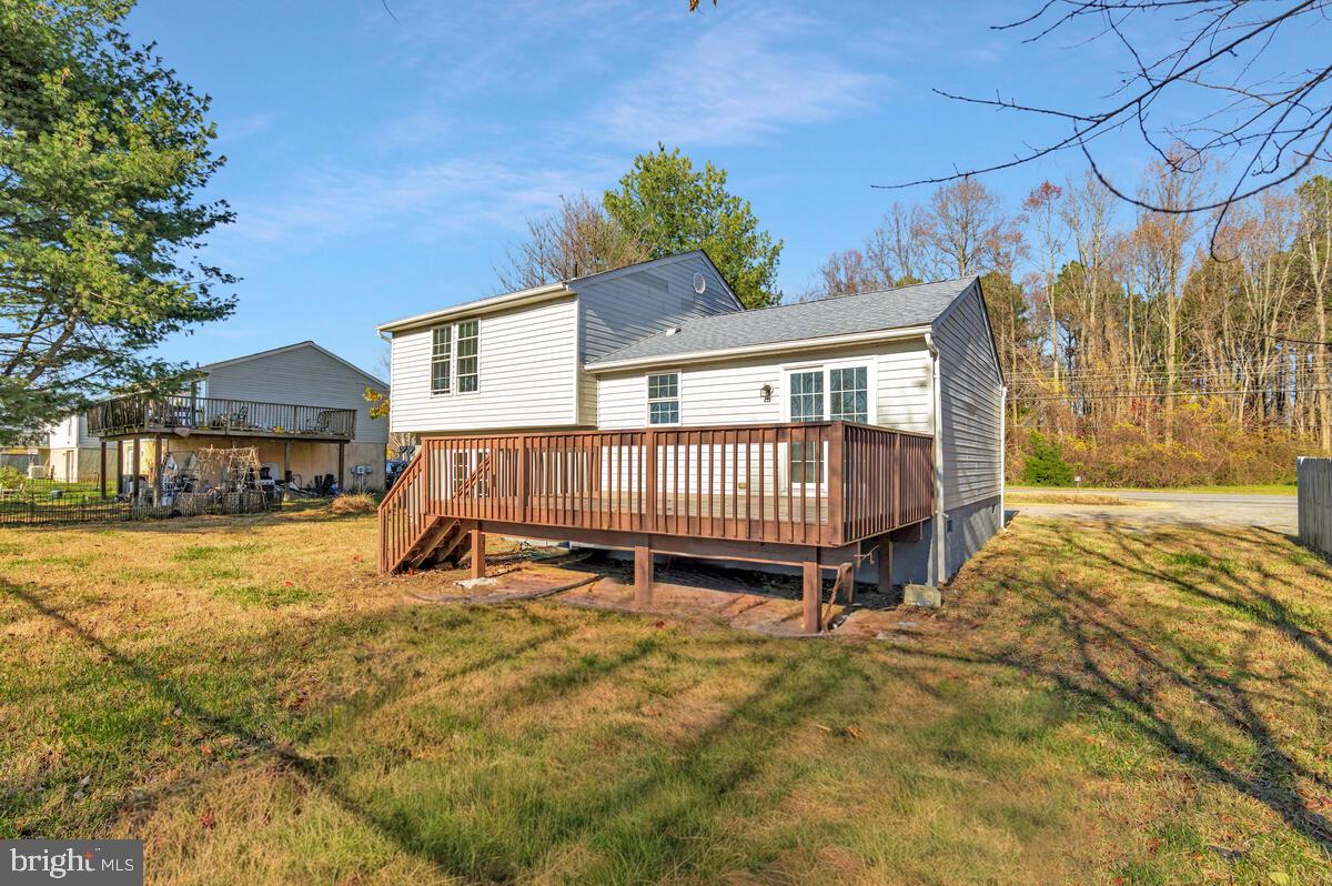 123 Cove Point Road Lusby, MD 20657 - Photo 34 of 38 a view of a house with a yard and deck