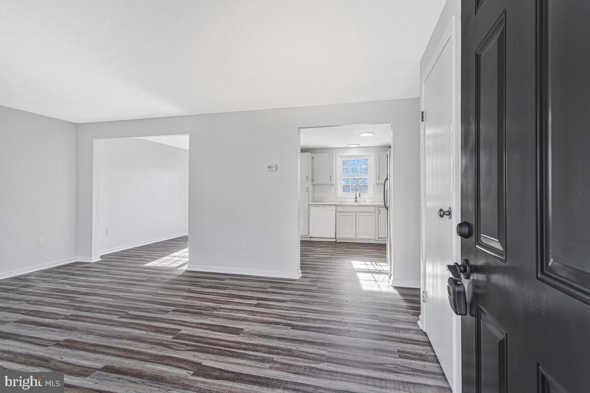 123 Cove Point Road Lusby, MD 20657 - Photo 5 of 38 a view of a hallway with wooden floor