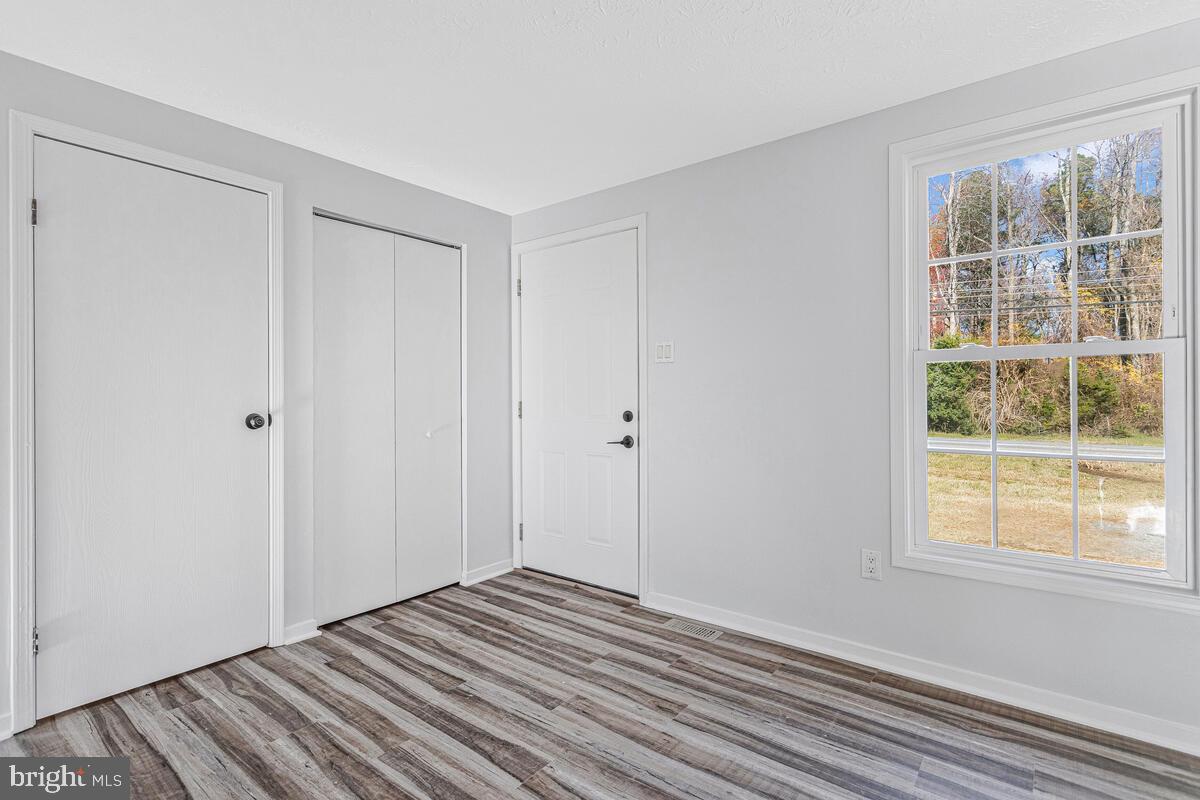 123 Cove Point Road Lusby, MD 20657 - Photo 6 of 38 a view of a room with wooden floor and window