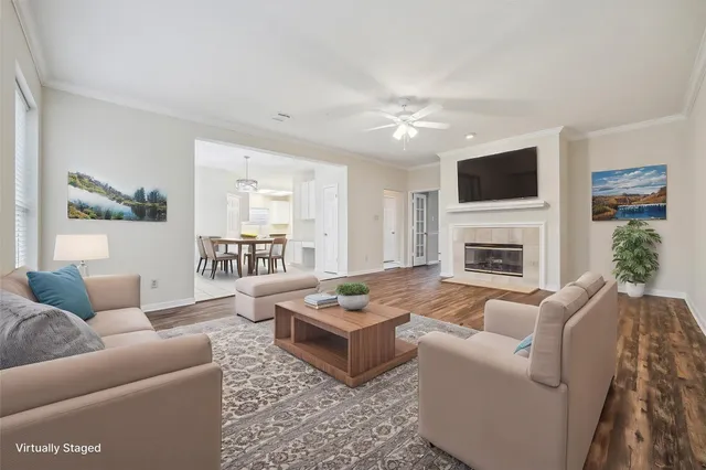 a living room with furniture a flat screen tv and a fireplace