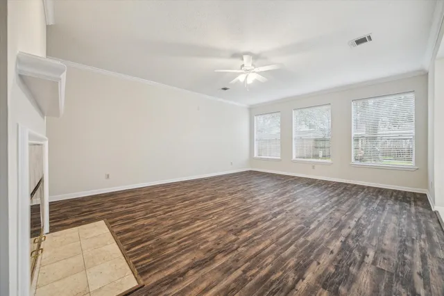 wooden floor in an empty room with a window