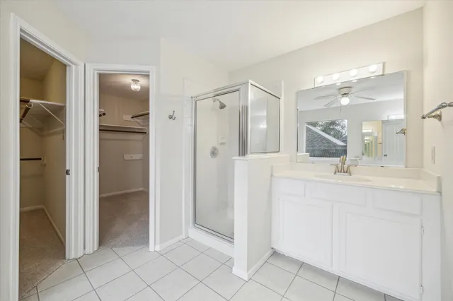 a bathroom with a shower sink and mirror