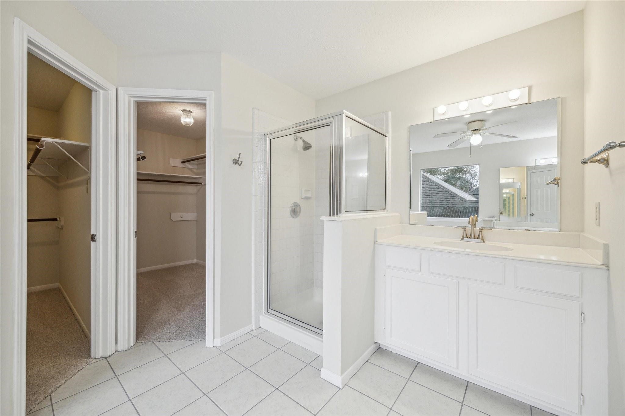 16403 Wellers Way Houston, TX 77095 - Photo 15 of 26 a bathroom with a shower sink and mirror