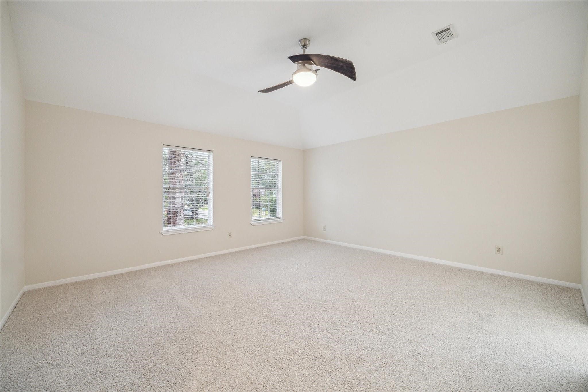 16403 Wellers Way Houston, TX 77095 - Photo 19 of 26 an empty room with windows and fan