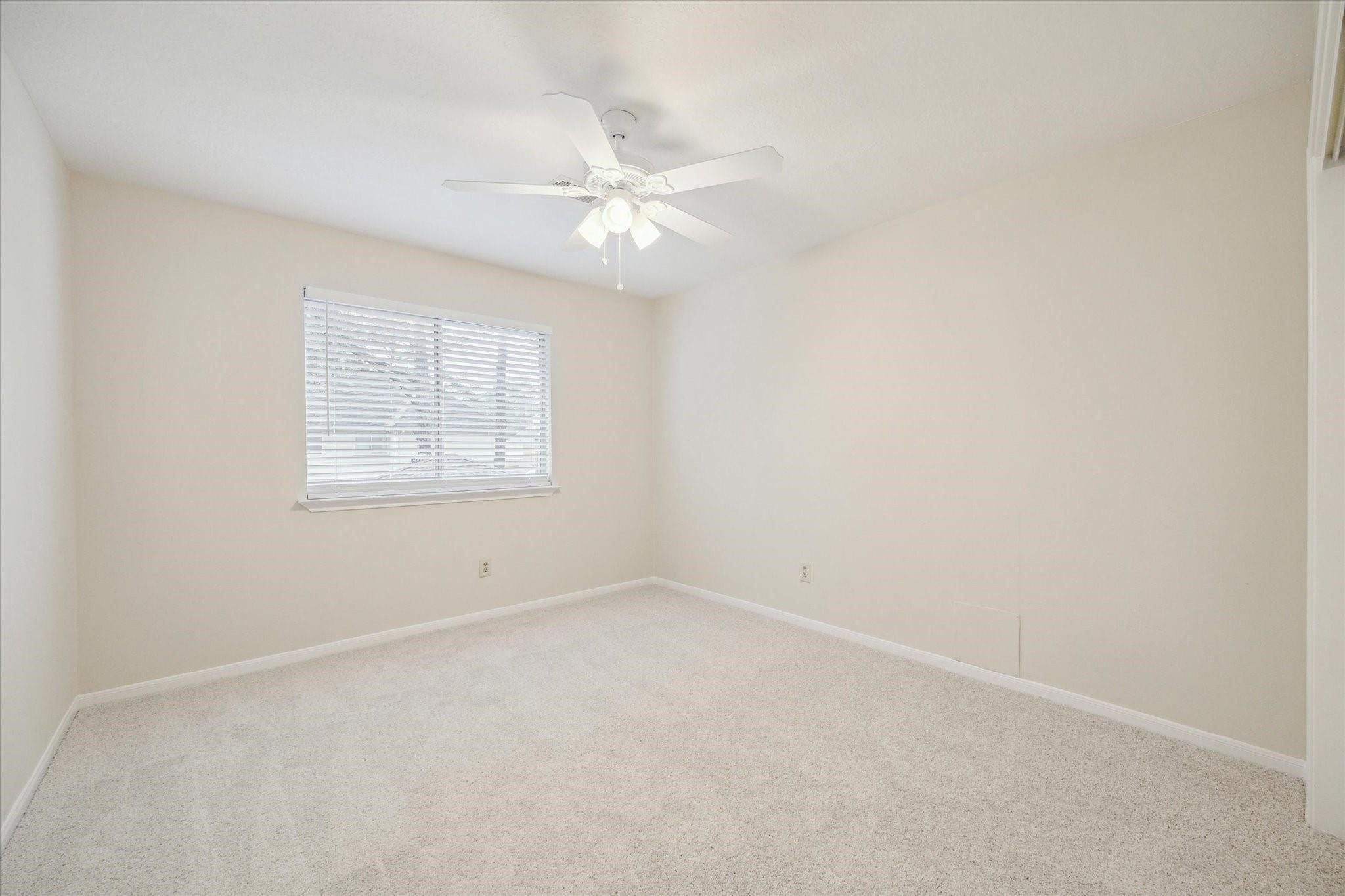 16403 Wellers Way Houston, TX 77095 - Photo 21 of 26 an empty room with a window and ceiling fan