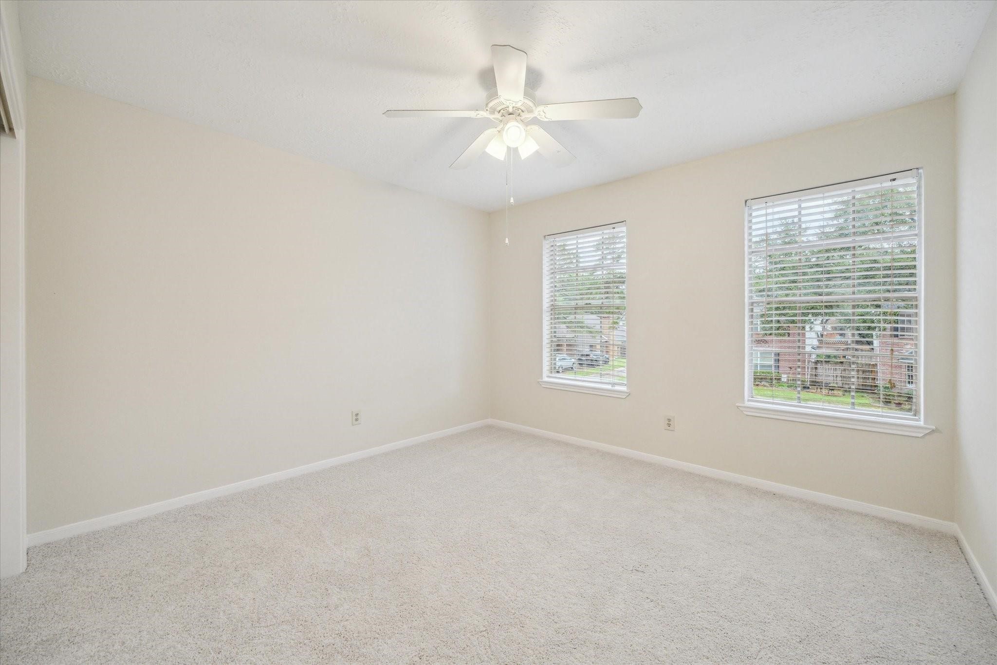16403 Wellers Way Houston, TX 77095 - Photo 22 of 26 an empty room with a window and a ceiling fan