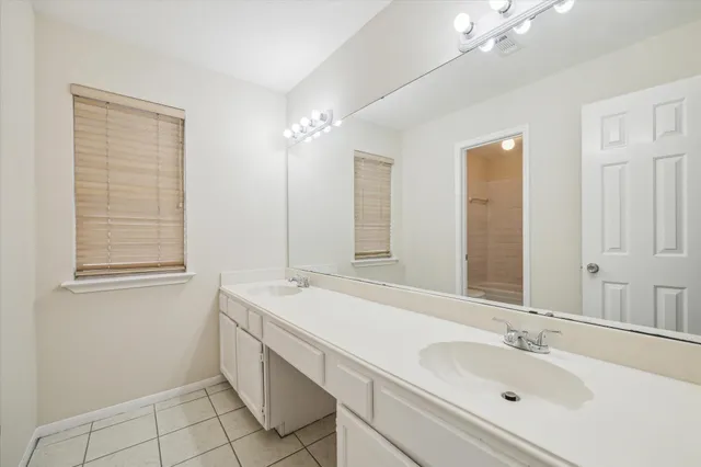 a bathroom with a sink double vanity and a mirror